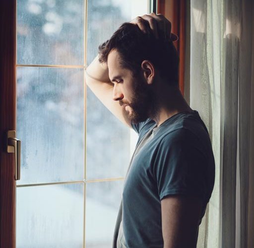 sobergrind-How-Enabling-Hurts-photo-of-depressed-man-near-the-window